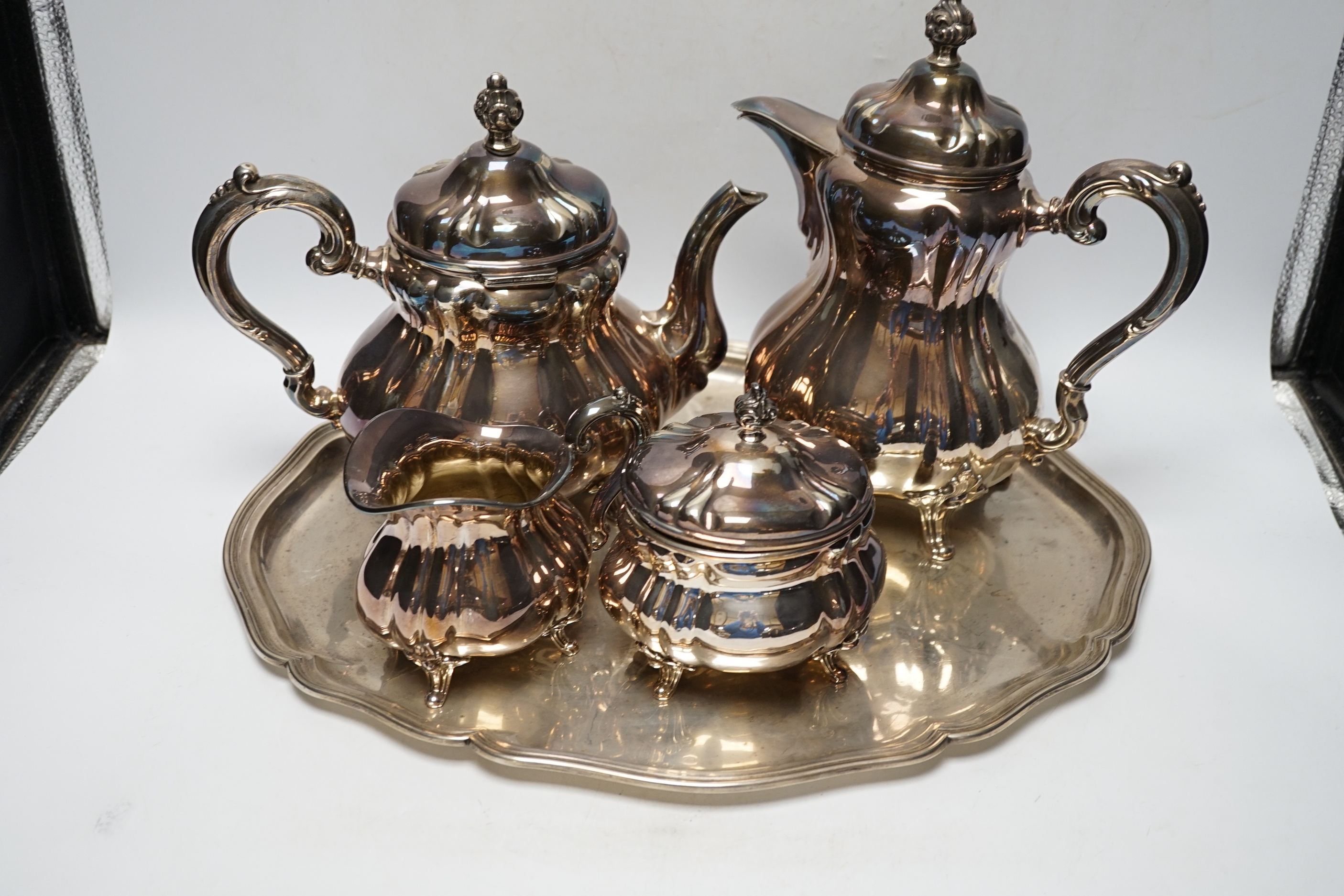 A German 835 standard white metal four piece tea set by Wilhelm Binder and a 830 standard white metal oval tray, gross weight 102.5oz.